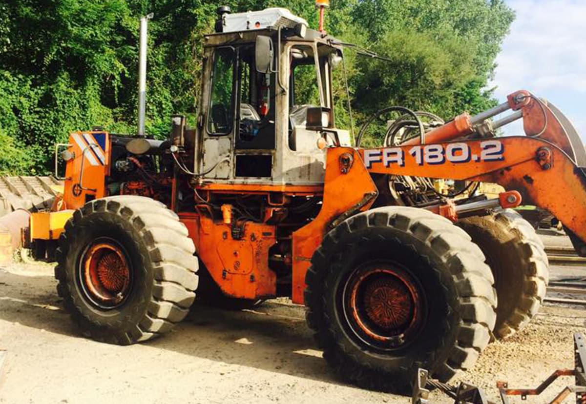 Industrial wheel loader with weathered paint and corrosion