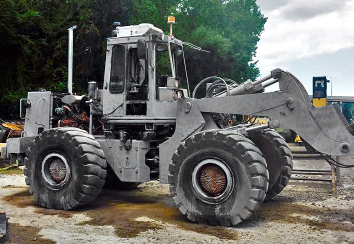 Wheel loader during and after abrasive surface preparation