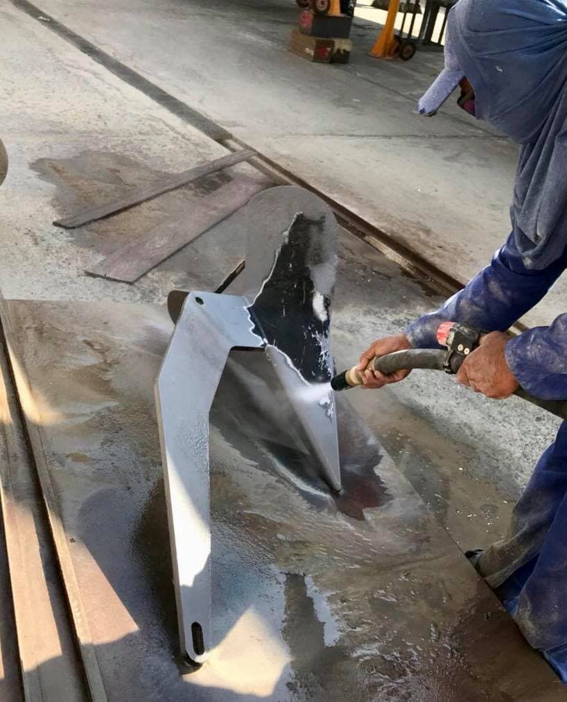 Blast nozzle preparing a marine component